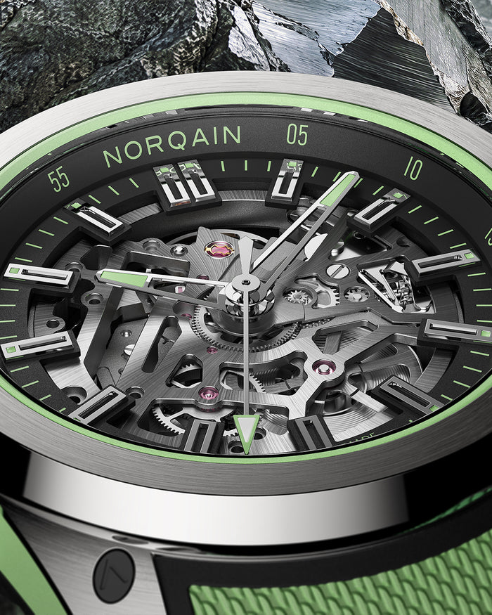 Macro view of NORQAIN skeleton calibre and mint lume hour indexes